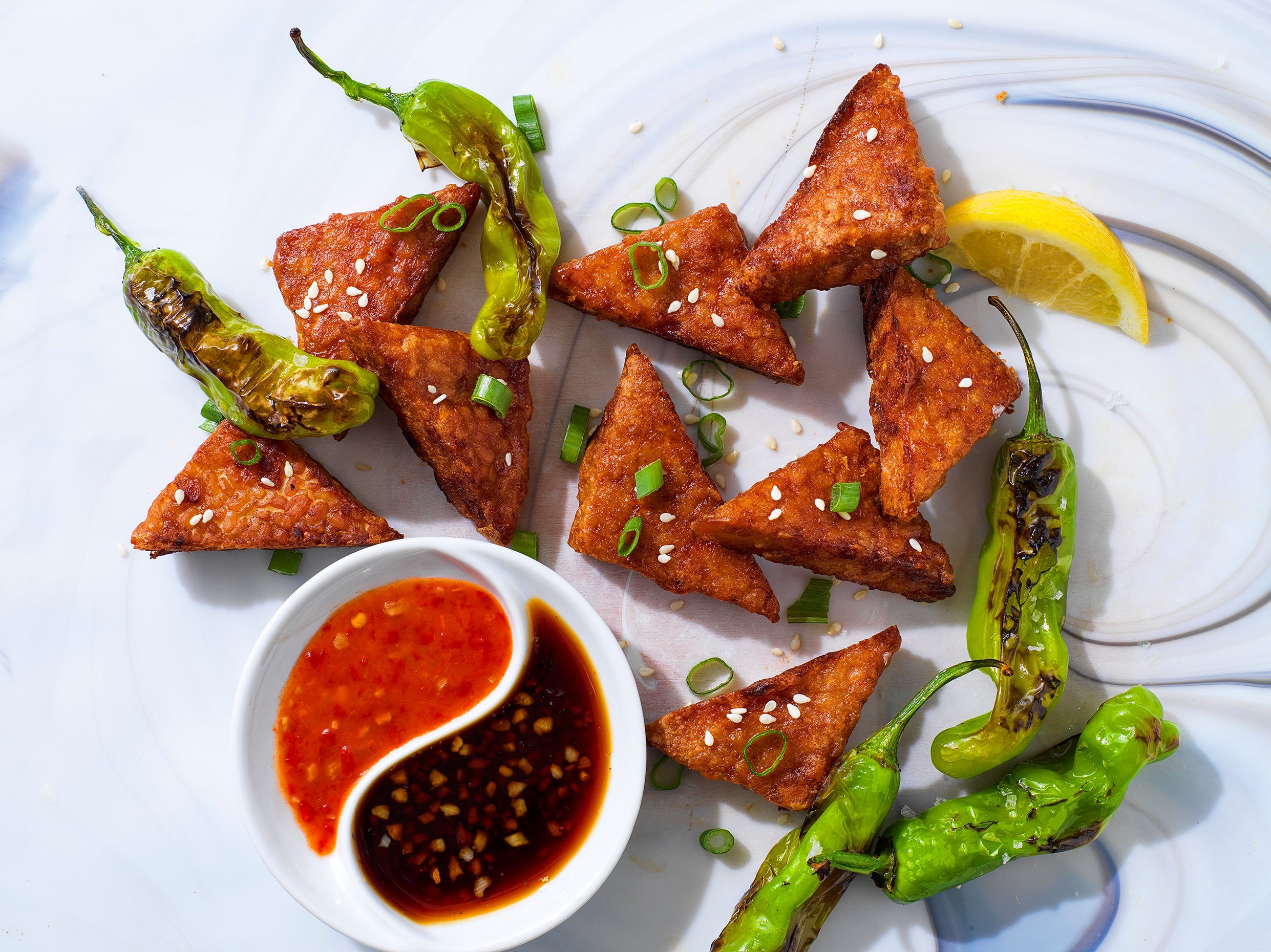 Image of crispy wedges made from Planit Ivory Lentil tempeh and koji dipping sauces